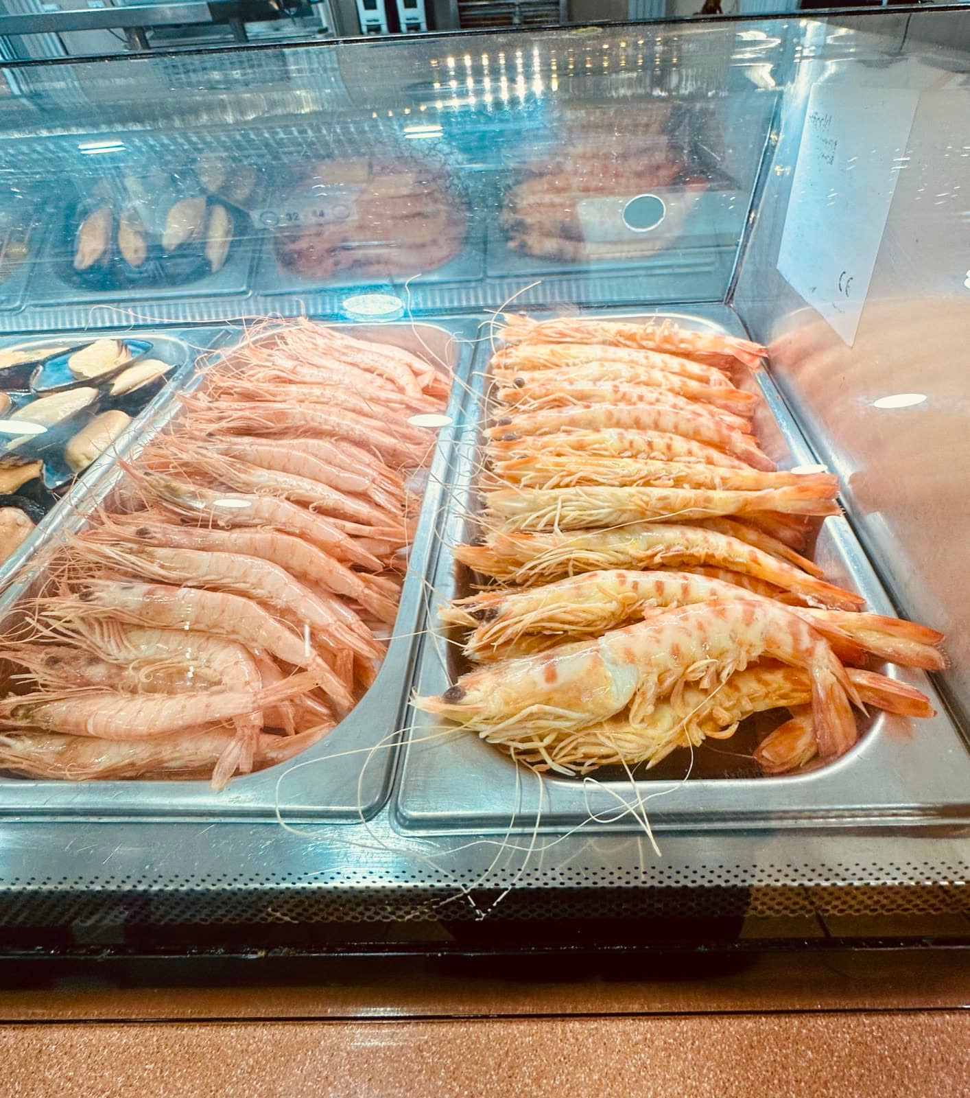 Langostinos y gambas en la vitrina de la barra